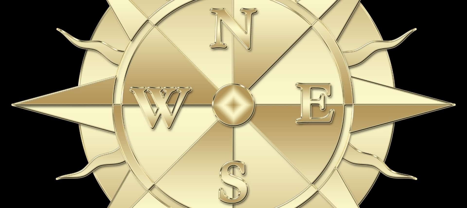 Gold compass with N, E, S, W on a black background